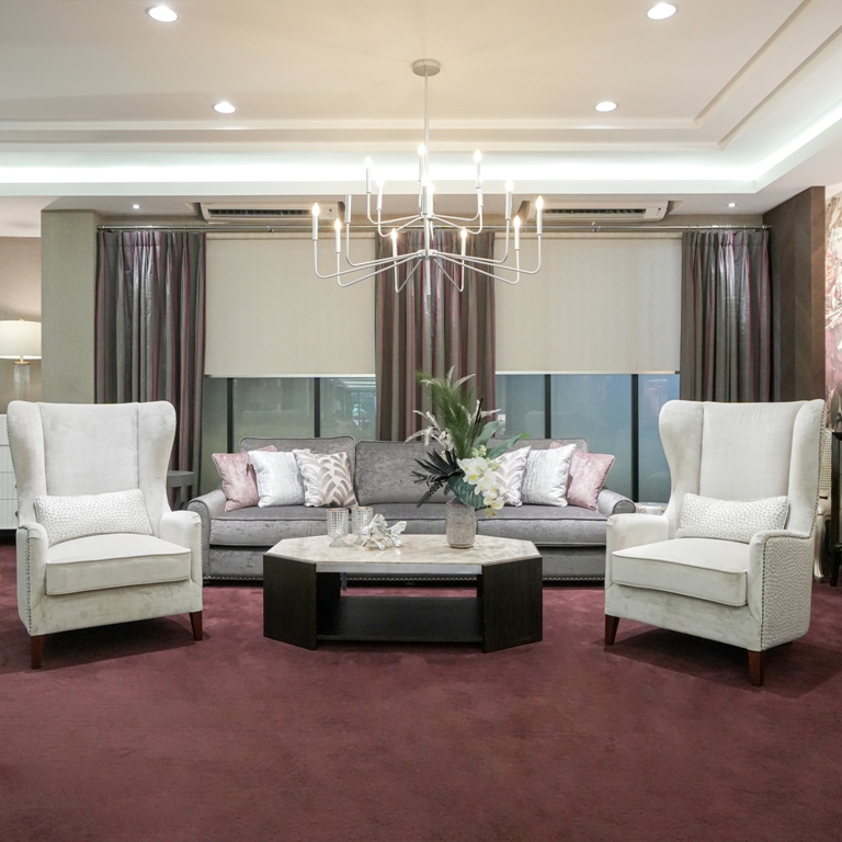 An impeccably designed living room showcasing an elegant sofa set from Home Decor Indonesia, complemented by stylish decor and a warm, inviting ambiance that epitomizes modern luxury.
