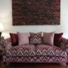 A beautifully styled living room interior by Home Decor Indonesia, featuring a coordinated furniture set with elegant textiles and ambient lighting that creates a warm, inviting, and luxurious atmosphere.