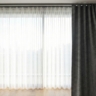 A straight-on shot of a window with a dual-track system.